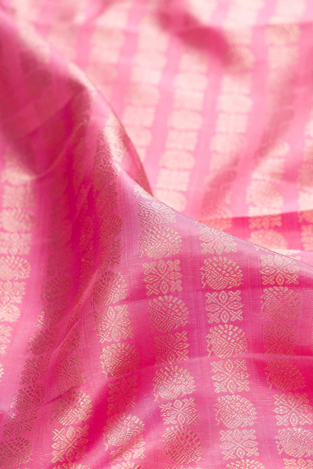 Close up of Pure Silk Pink Kanchipuram Saree with Zari Brocade on the body and Zari Border.  displaying folds