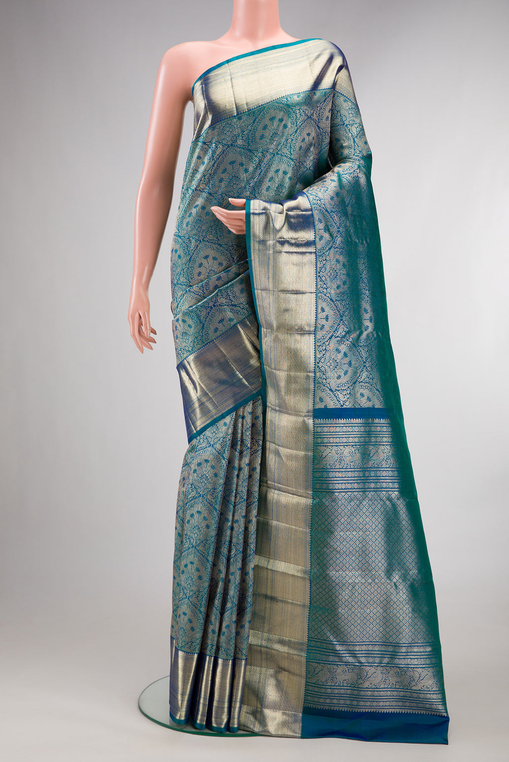 Pure Silk Peacock Blue Dual Tone Kanchipuram Saree with Zari Brocade on the body and Zari Border.  displayed on a mannequin