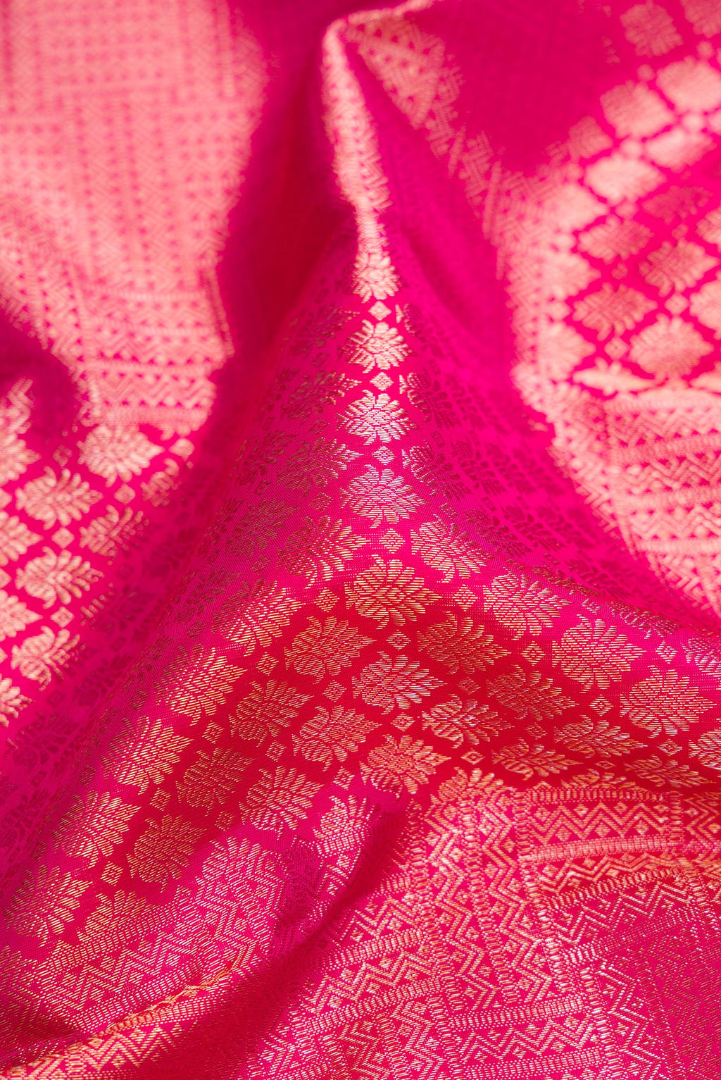Close up of Pure Silk Pink Kanchipuram Saree with Zari Brocade on the body and Fancy Border.  displaying folds