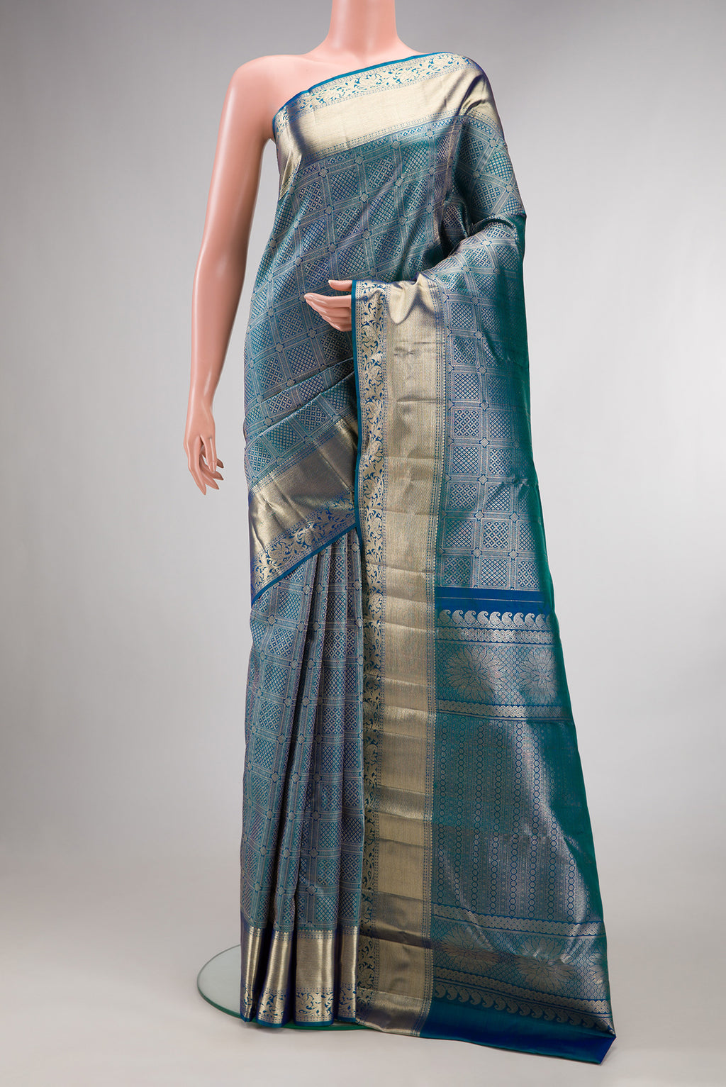 Pure Silk Peacock Blue Dual Tone Kanchipuram Saree with Zari Brocade on the body and Fancy Border.  displayed on a mannequin