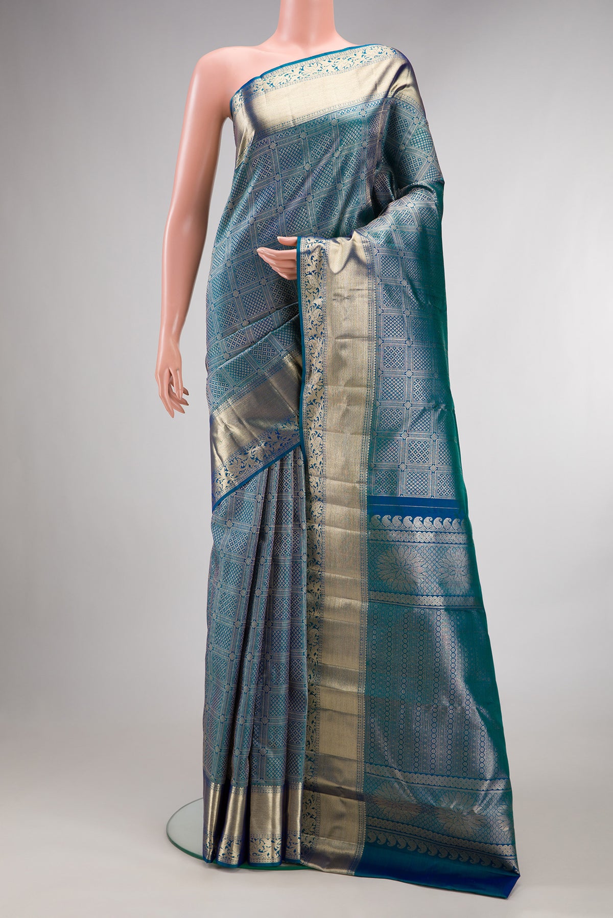 Pure Silk Peacock Blue Dual Tone Kanchipuram Saree with Zari Brocade on the body and Fancy Border.  displayed on a mannequin