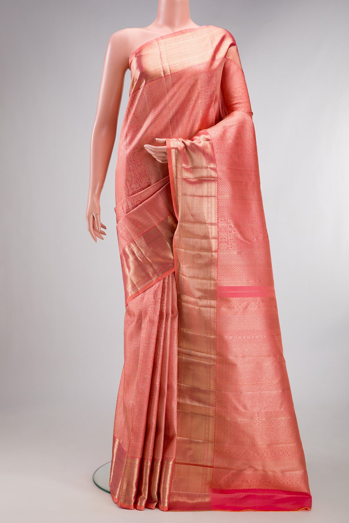 Pure Silk Golden Peach Dual Tone Kanchipuram Saree with Zari Brocade on the body and Zari Border.  displayed on a mannequin