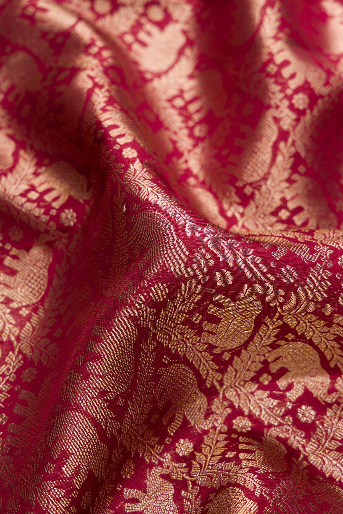 Close up of Pure Silk Maroon Dual Tone Kanchipuram Saree with Zari Brocade on the body and Zari Border.  displaying folds