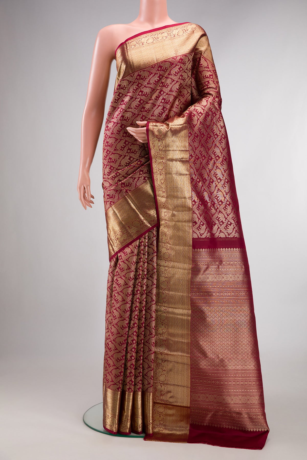 Pure Silk Maroon Dual Tone Kanchipuram Saree with Zari Brocade on the body and Zari Border.  displayed on a mannequin
