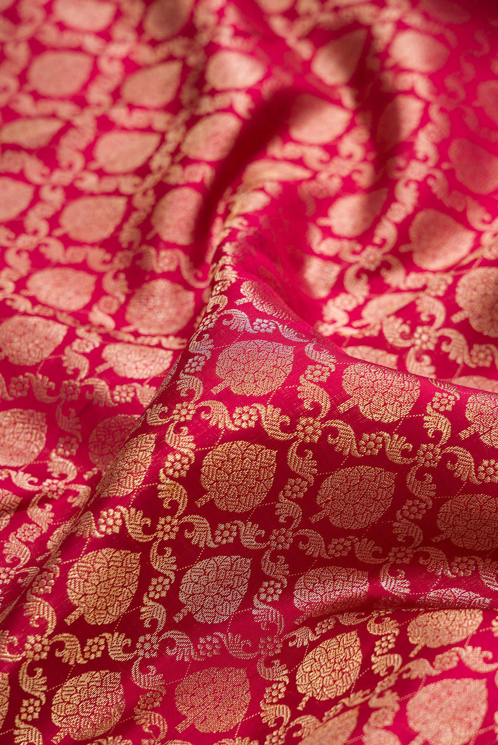 Close up of Pure Silk Deep Red Dual Tone Kanchipuram Saree with Zari Brocade on the body and Zari Border.  displaying folds