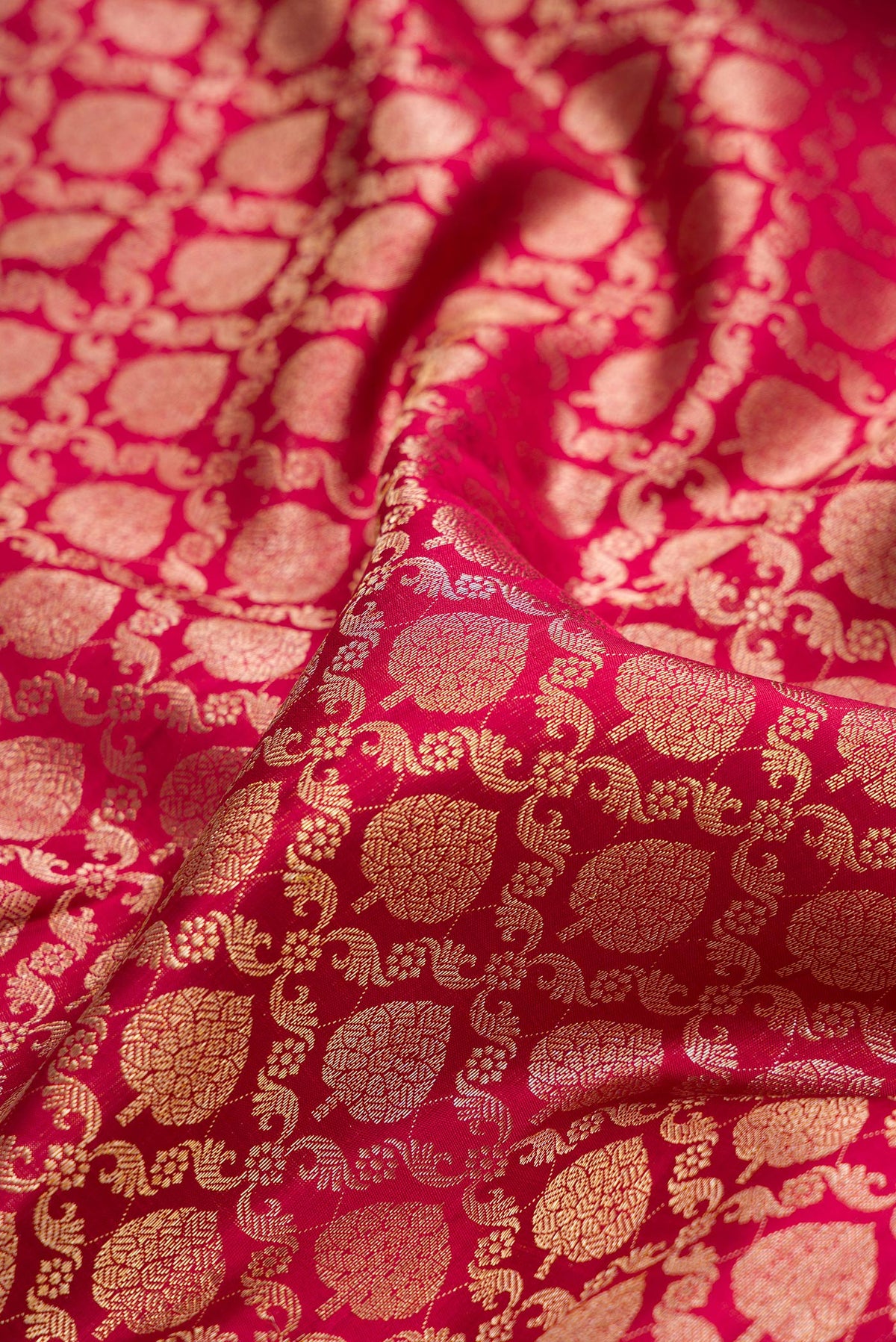 Close up of Pure Silk Deep Red Dual Tone Kanchipuram Saree with Zari Brocade on the body and Zari Border.  displaying folds