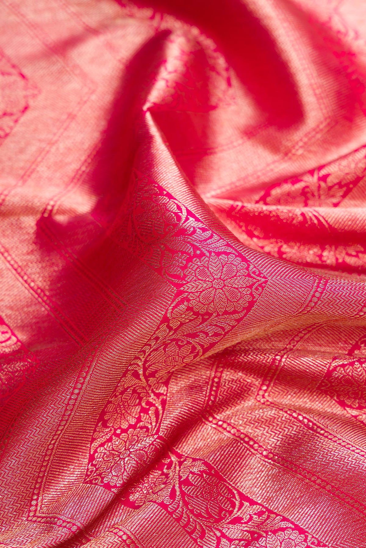Close up of Pure Silk Pink Dual Tone Kanchipuram Saree with Zari Brocade on the body and Zari Border.  displaying folds