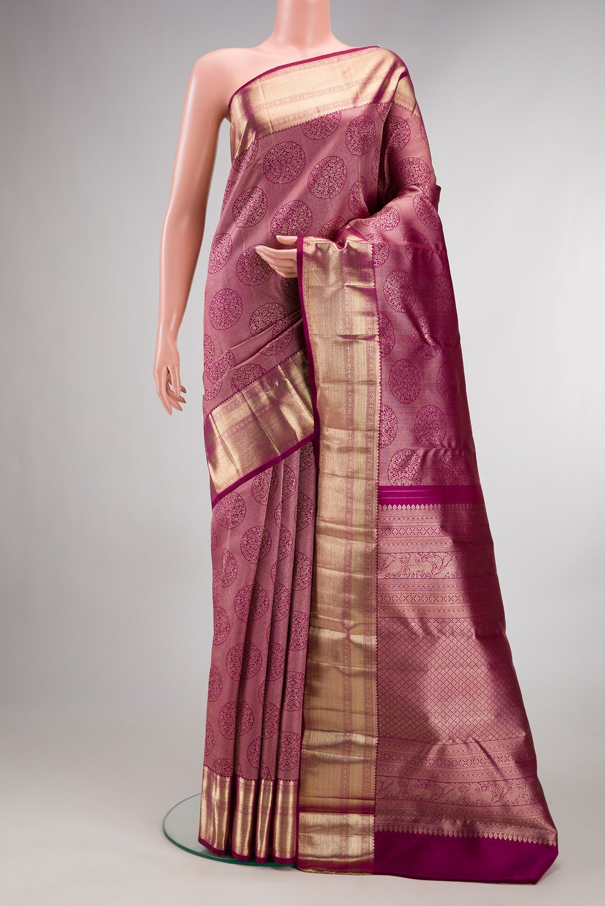 Pure Silk Dark Pink Kanchipuram Saree with Zari Brocade on the body and Zari Border.  displayed on a mannequin