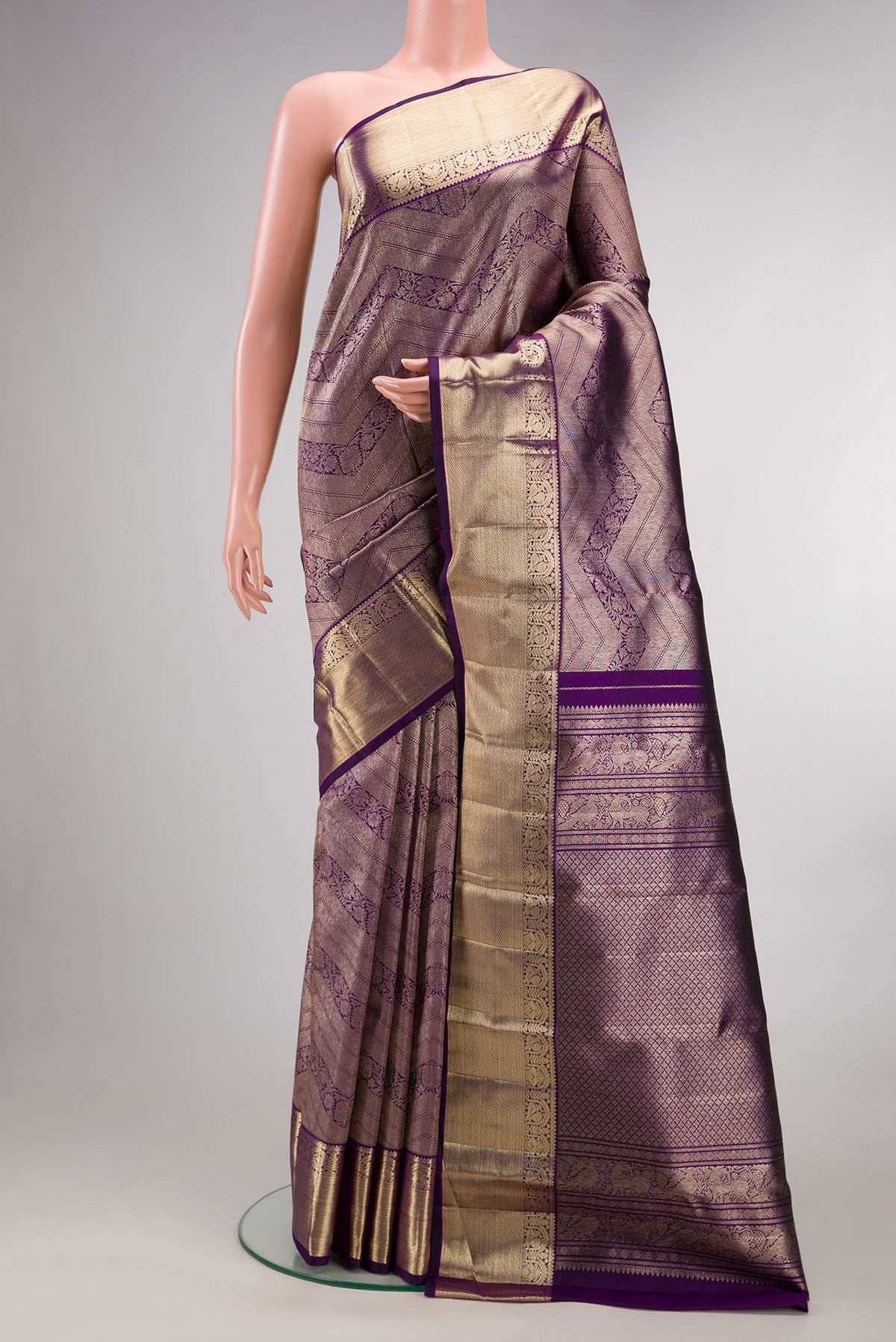 Pure Silk Purple Kanchipuram Saree with Zari Brocade on the body and Zari Border.  displayed on a mannequin