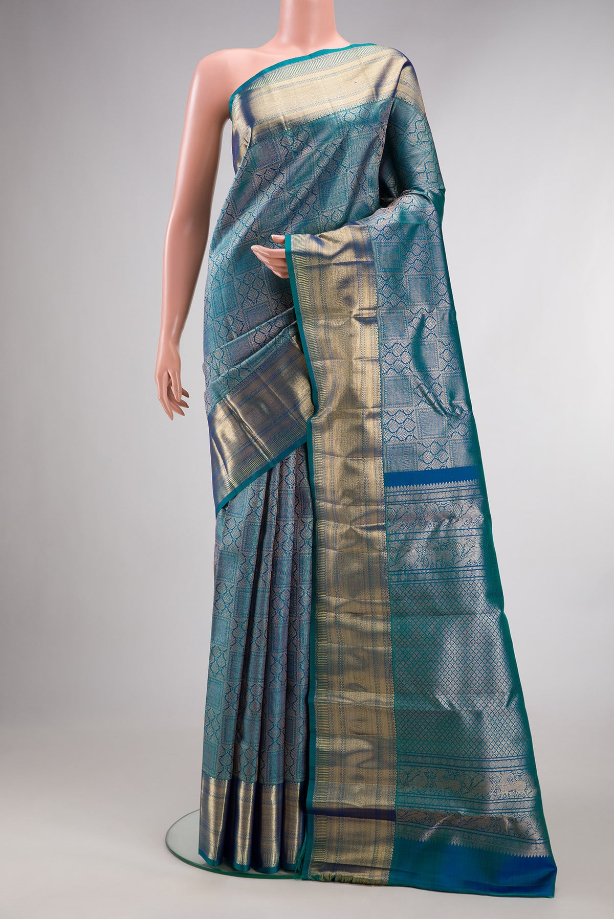Pure Silk Peacock Blue Dual Tone Kanchipuram Saree with Zari Brocade on the body and Zari Border.  displayed on a mannequin