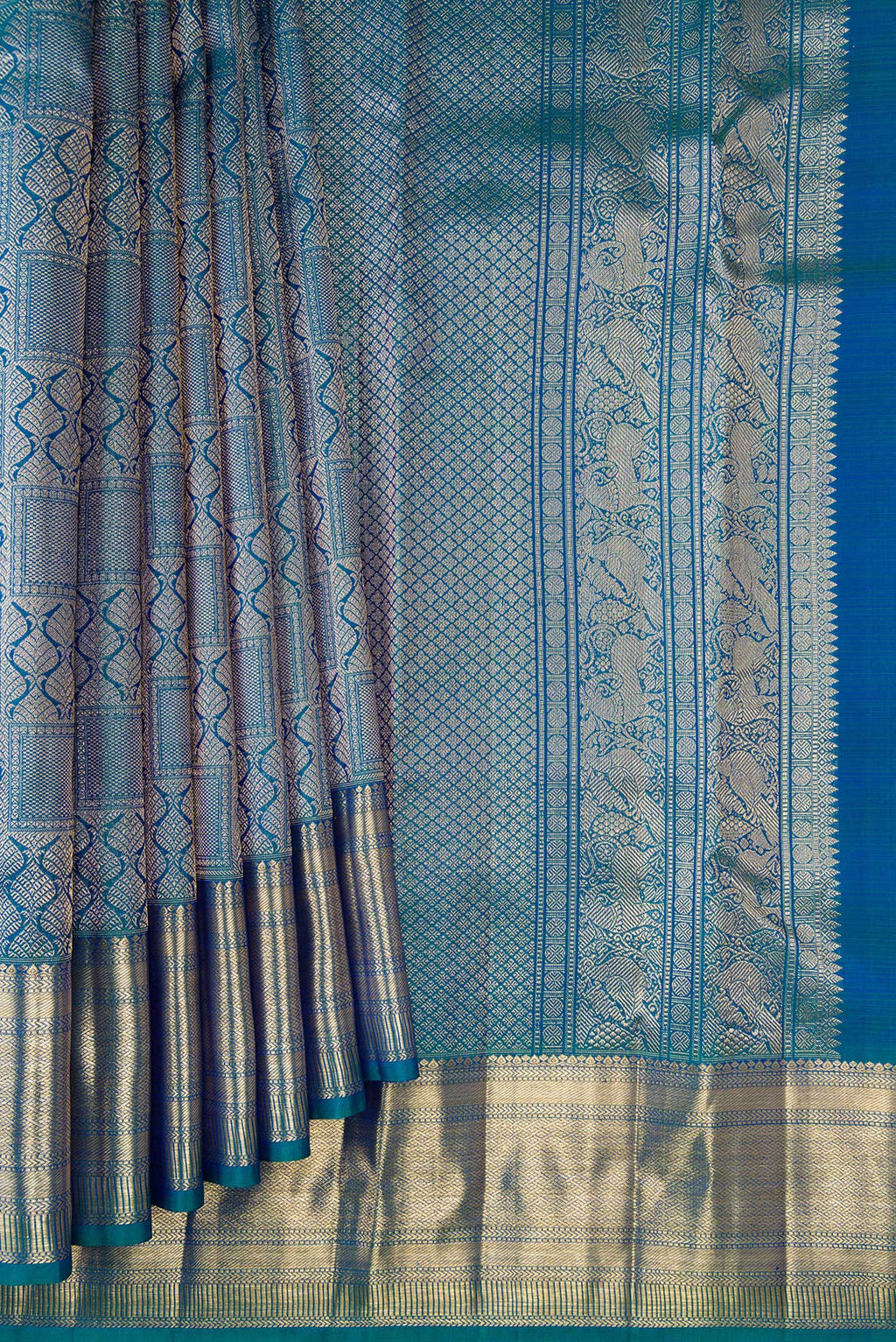 Pleats and pallu of Pure Silk Peacock Blue Dual Tone Kanchipuram Saree with Zari Brocade on the body and Zari Border. 