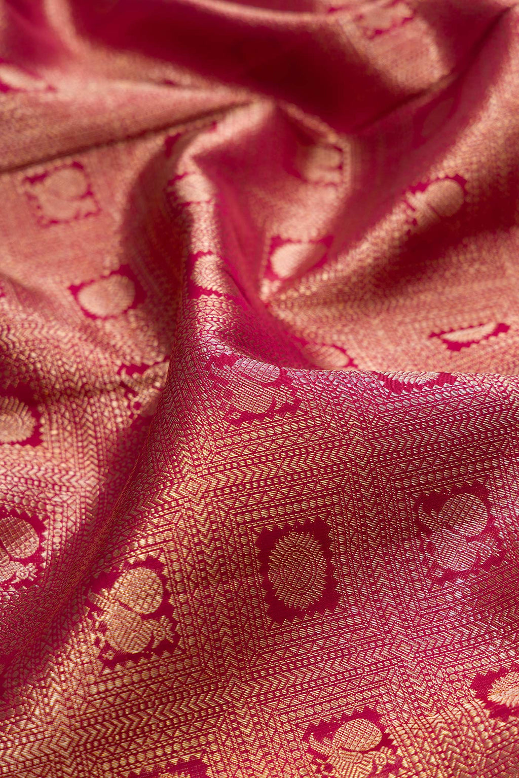Close up of Pure Silk Maroon Kanchipuram Saree with Zari Brocade on the body and Zari Border.  displaying folds