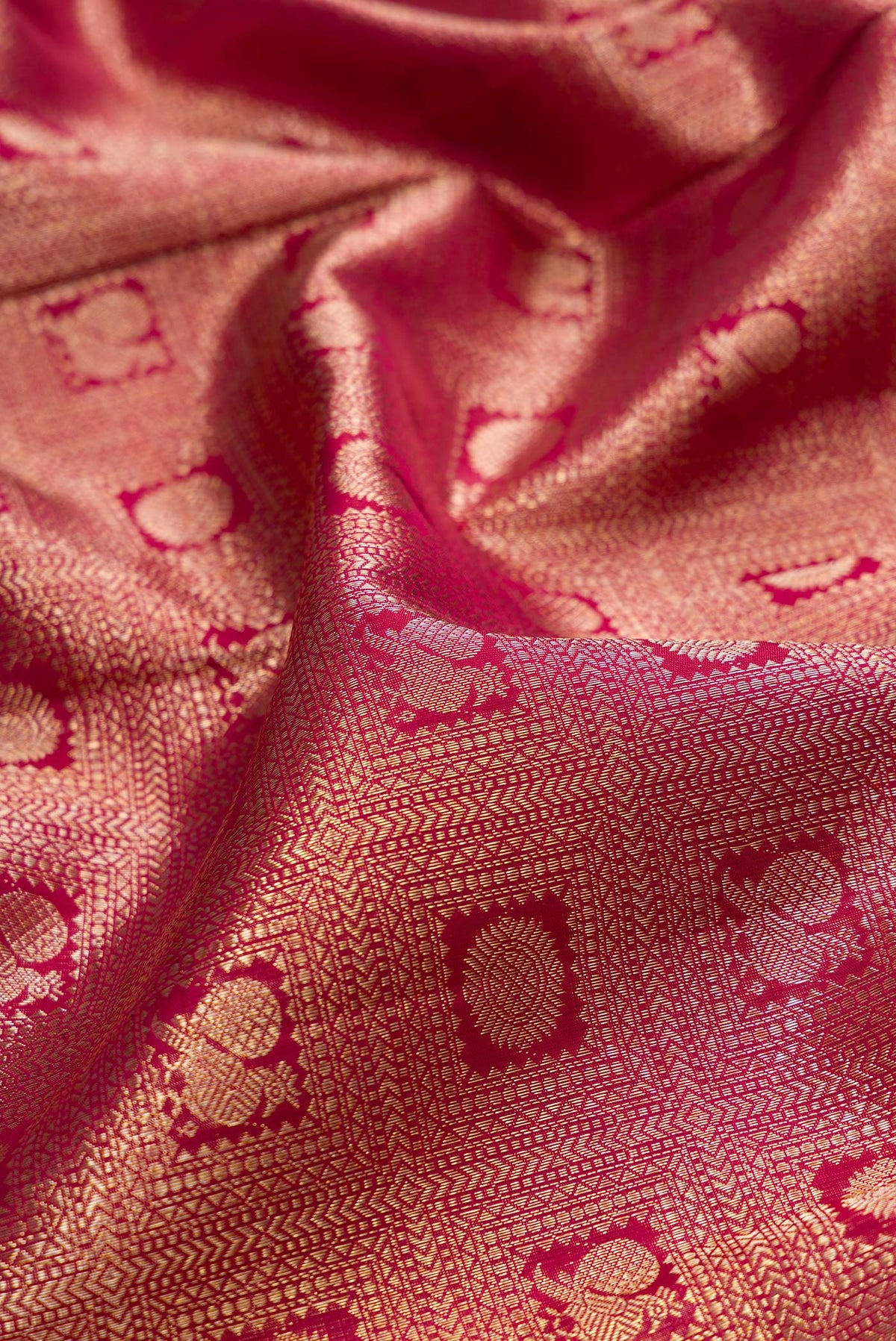 Close up of Pure Silk Maroon Kanchipuram Saree with Zari Brocade on the body and Zari Border.  displaying folds
