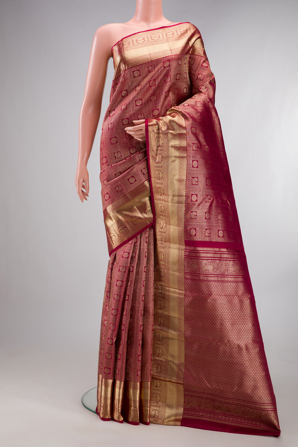 Pure Silk Maroon Kanchipuram Saree with Zari Brocade on the body and Zari Border.  displayed on a mannequin