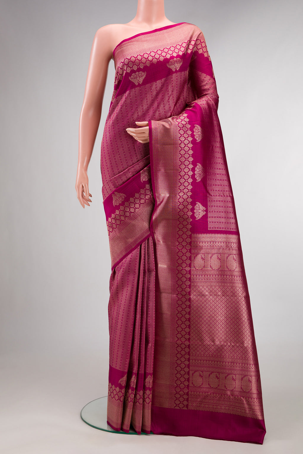 Pure Silk Dark Pink Kanchipuram Saree with Zari Brocade on the body and Zari Border.  displayed on a mannequin
