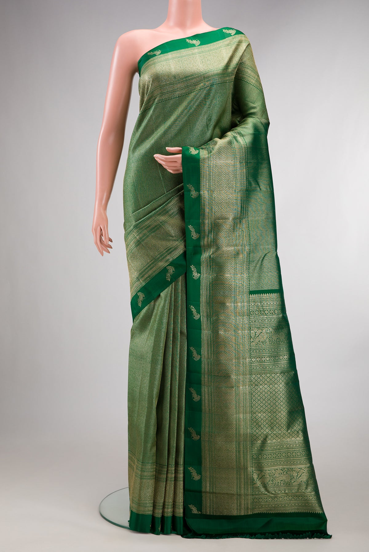 Pure Silk Bottle Green Dual Tone Kanchipuram Saree with Zari Brocade on the body and Fancy Border.  displayed on a mannequin