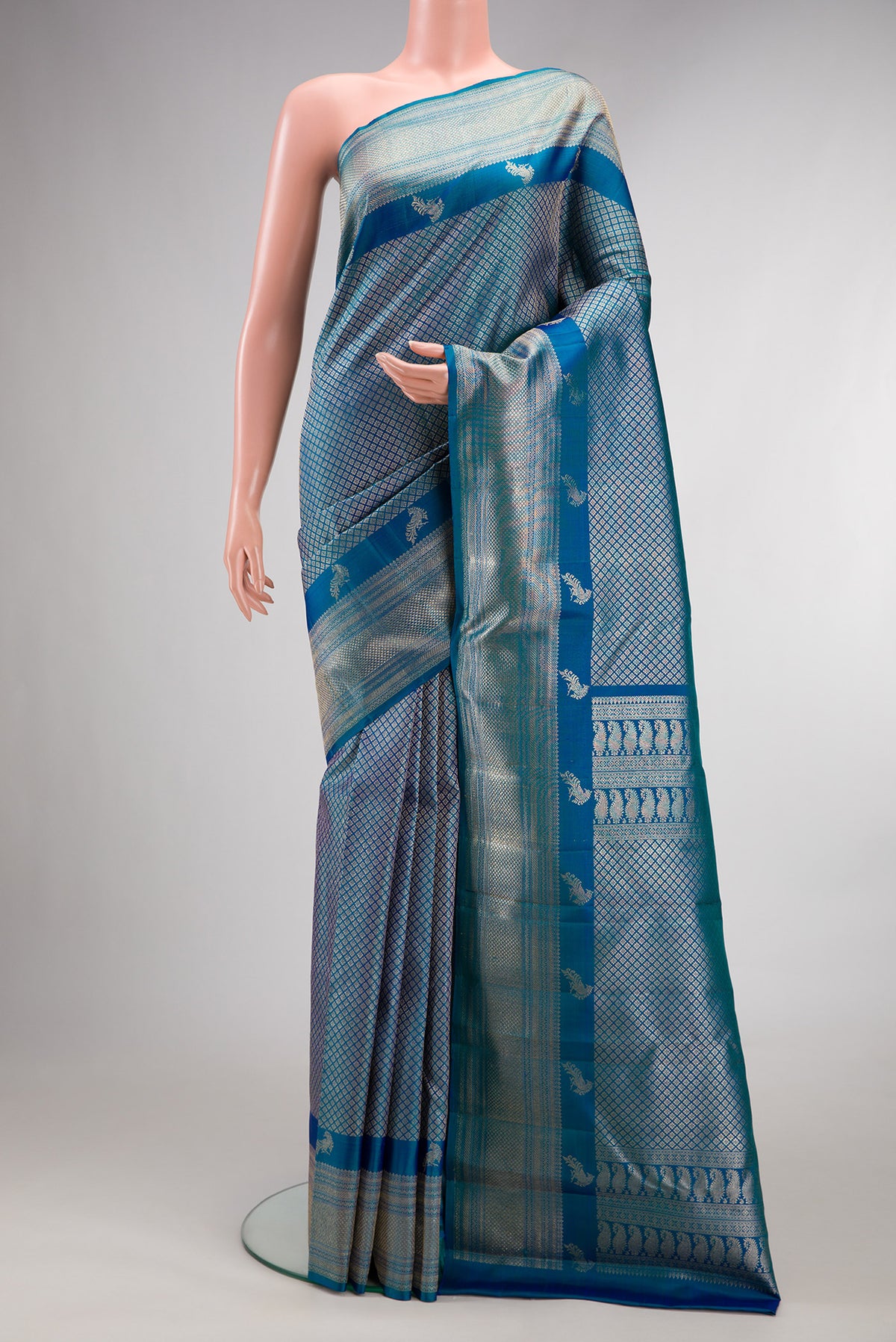 Pure Silk Peacock Blue Kanchipuram Saree with Zari Brocade on the body and Fancy Border.  displayed on a mannequin