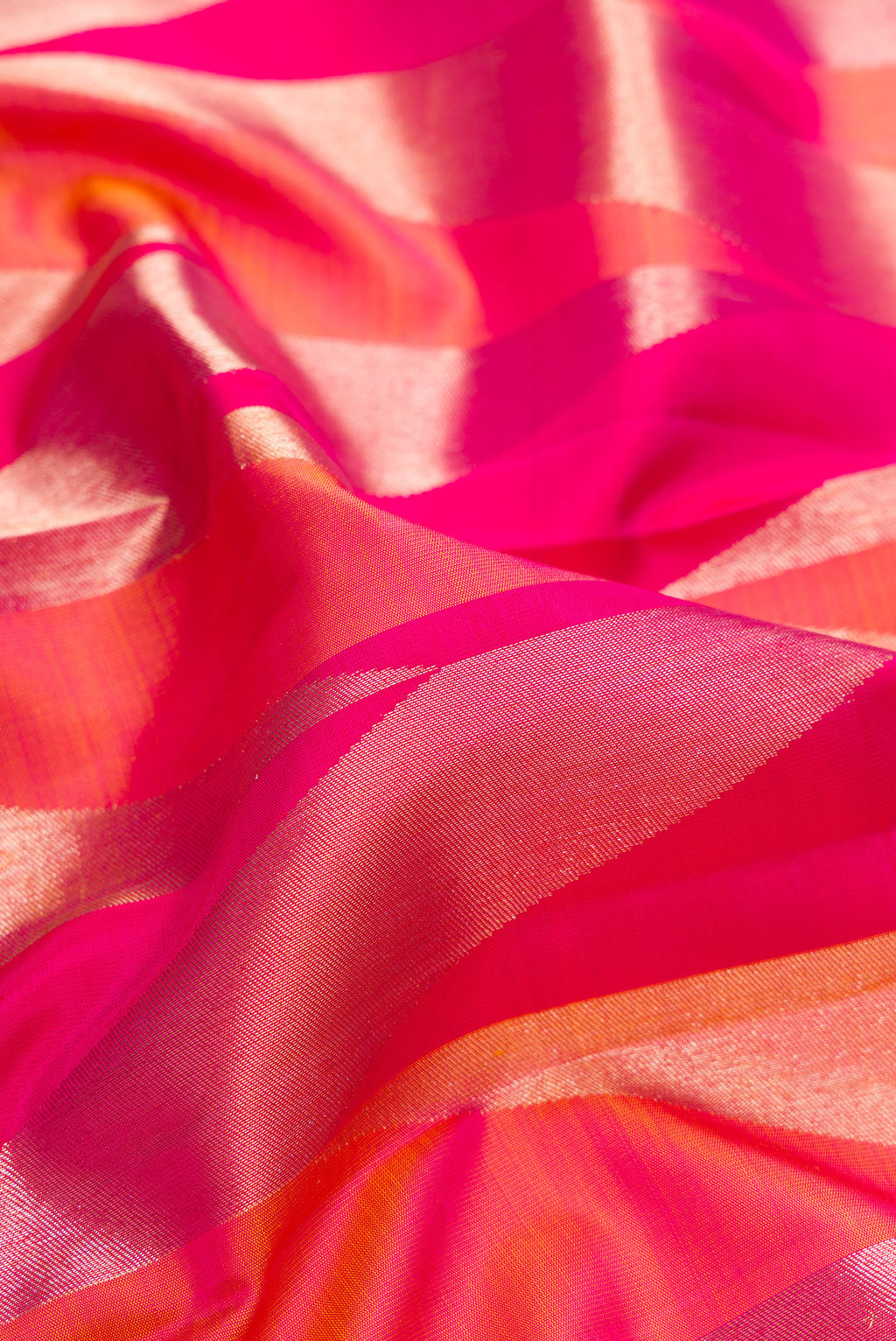 Close up of Pure Silk Dark Pink Dual Tone Kanchipuram Saree with Zari Brocade on the body and Zari Border.  displaying folds
