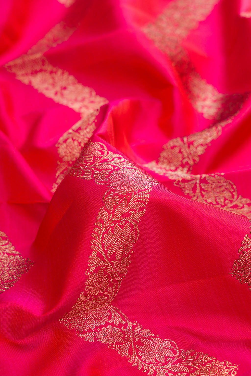 Close up of Pure Silk Pink Dual Tone Kanchipuram Saree with Stripes on the body and Zari Border.  displaying folds