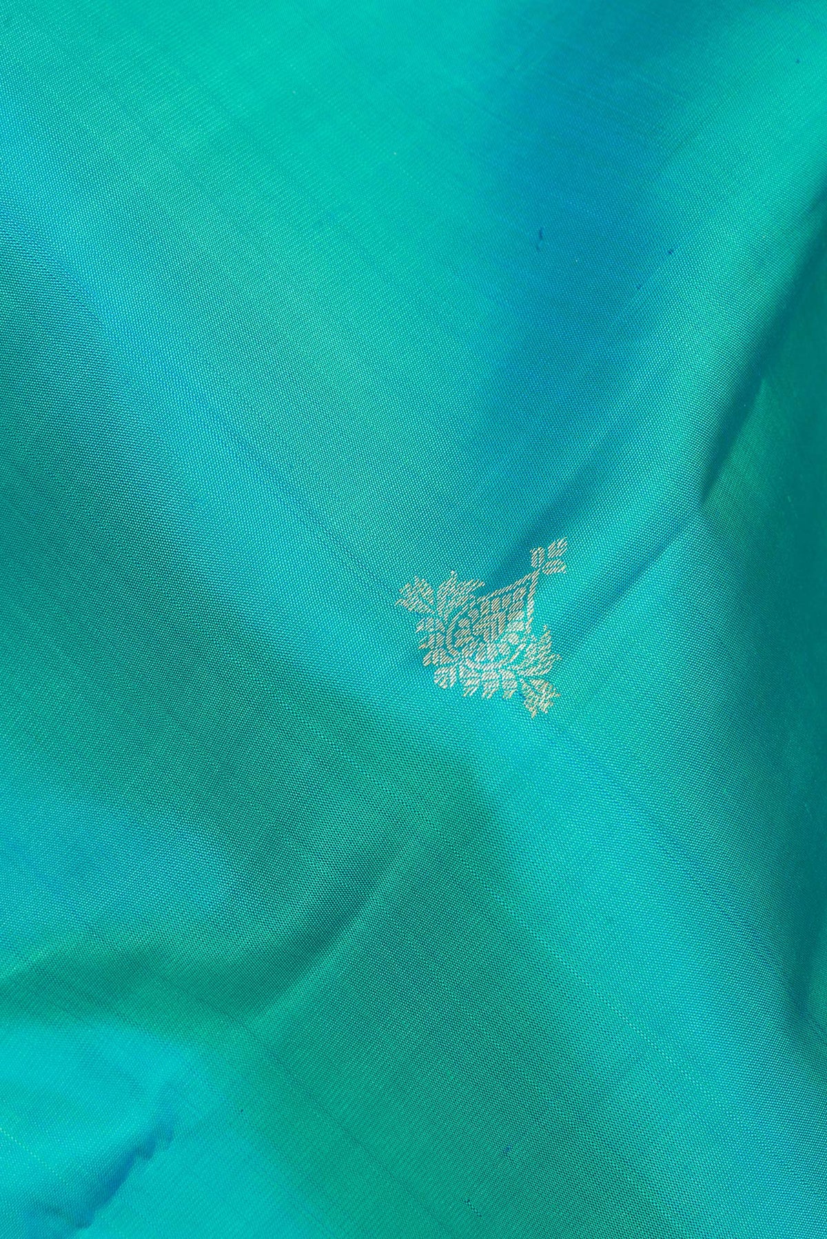 Close up of Pure Silk Turquoise Kanjivaram Saree with Zari Butta on the body and Fancy Border.  displaying folds