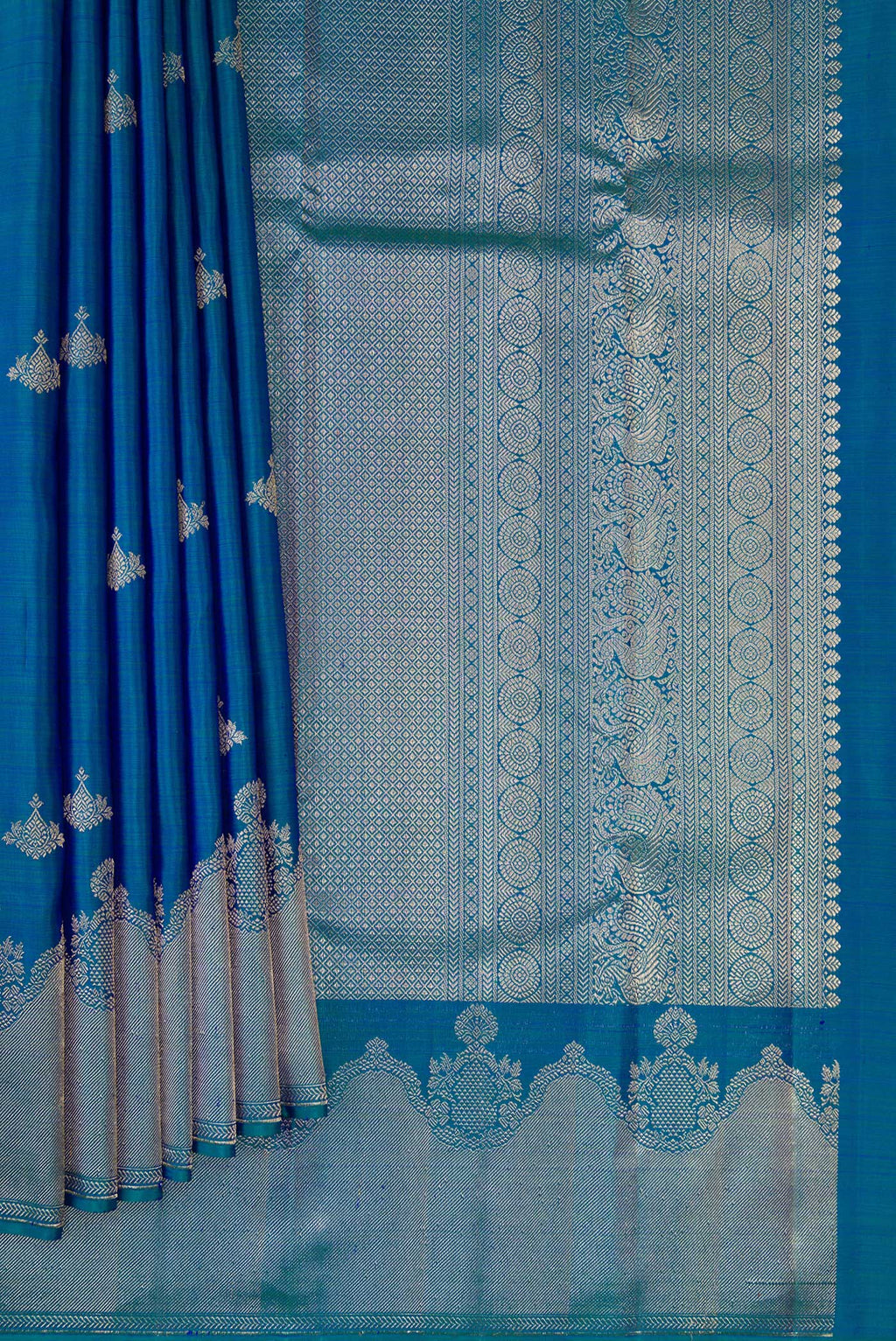 Pleats and pallu of Pure Silk Peacock Blue Dual Tone Kanjivaram Saree with Zari Butta on the body and Fancy Border. 