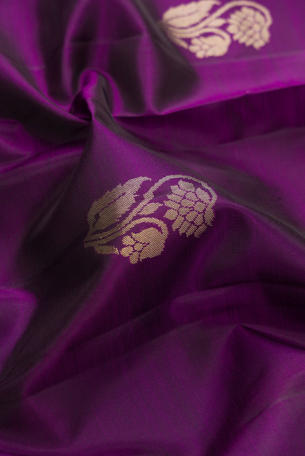 Close up of Pure Silk Purple Kanjivaram Saree with Zari Butta on the body and Zari Border.  displaying folds