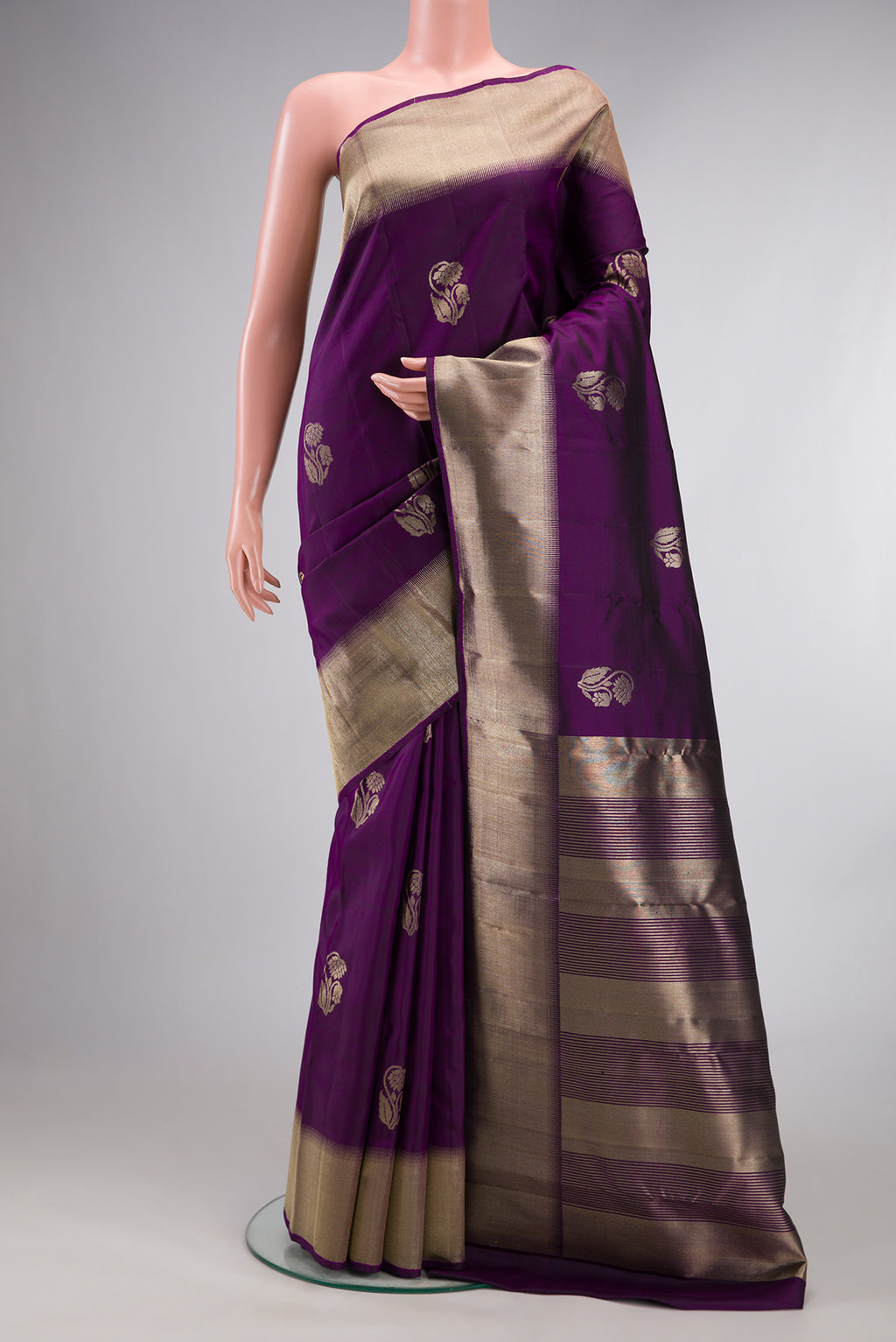 Pure Silk Purple Kanjivaram Saree with Zari Butta on the body and Zari Border.  displayed on a mannequin
