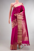 Pure Silk Rani Pink Kanjivaram Saree with Zari Butta on the body and Zari Border.  displayed on a mannequin