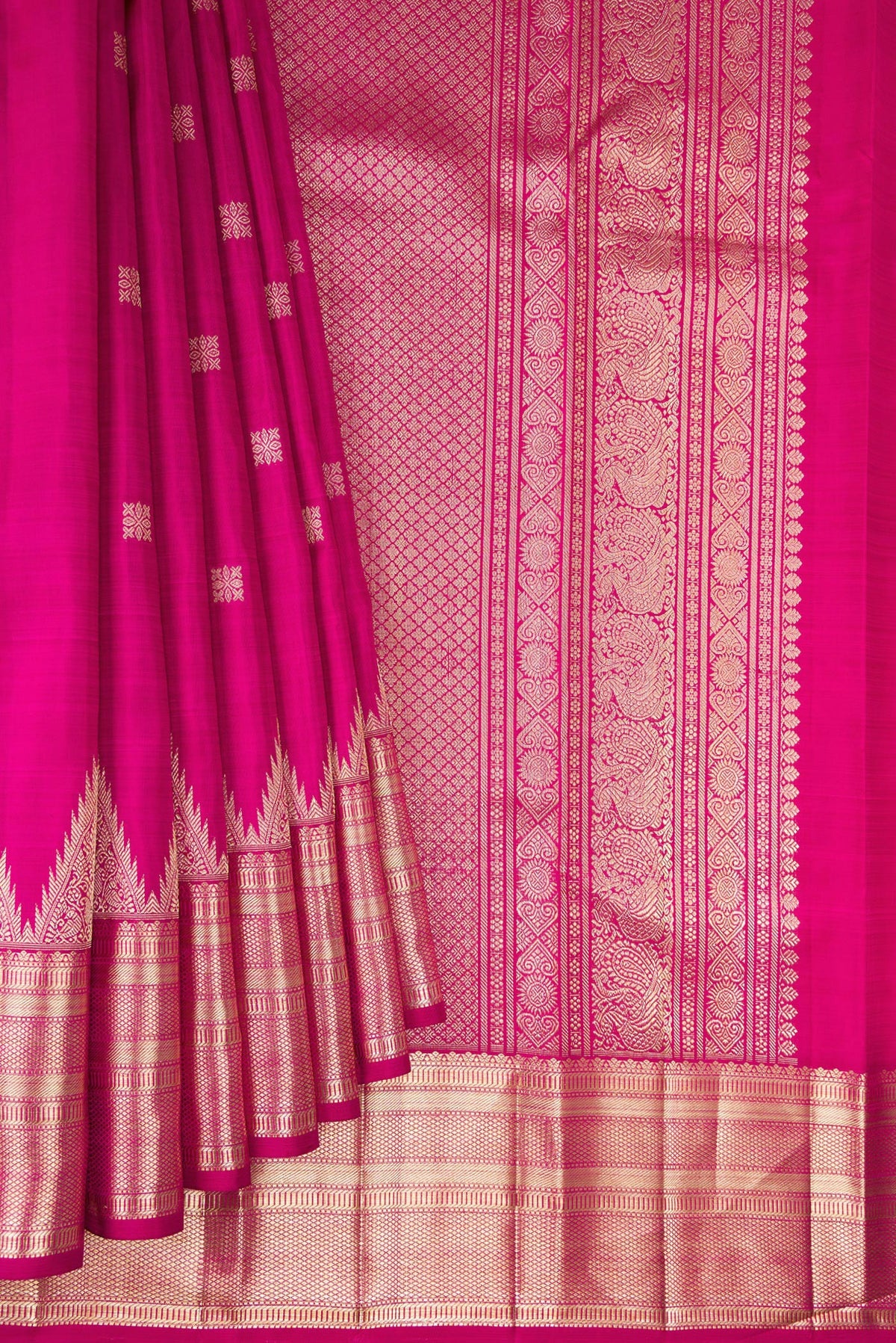 Pleats and pallu of Pure Silk Rani Pink Kanjivaram Saree with Zari Butta on the body and Zari Border. 