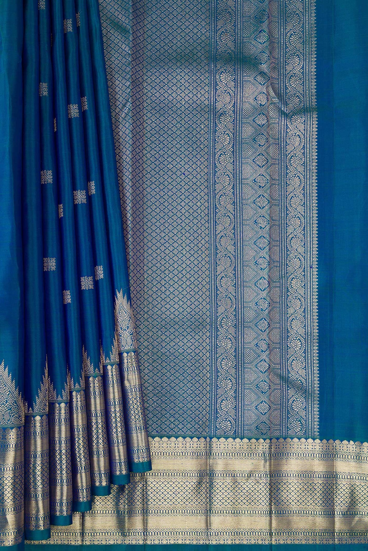 Pleats and pallu of Pure Silk Peacock Blue Dual Tone Kanjivaram Saree with Zari Butta on the body and Fancy Border. 