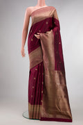 Pure Silk Maroon Kanjivaram Saree with Zari Butta on the body and Fancy Border.  displayed on a mannequin