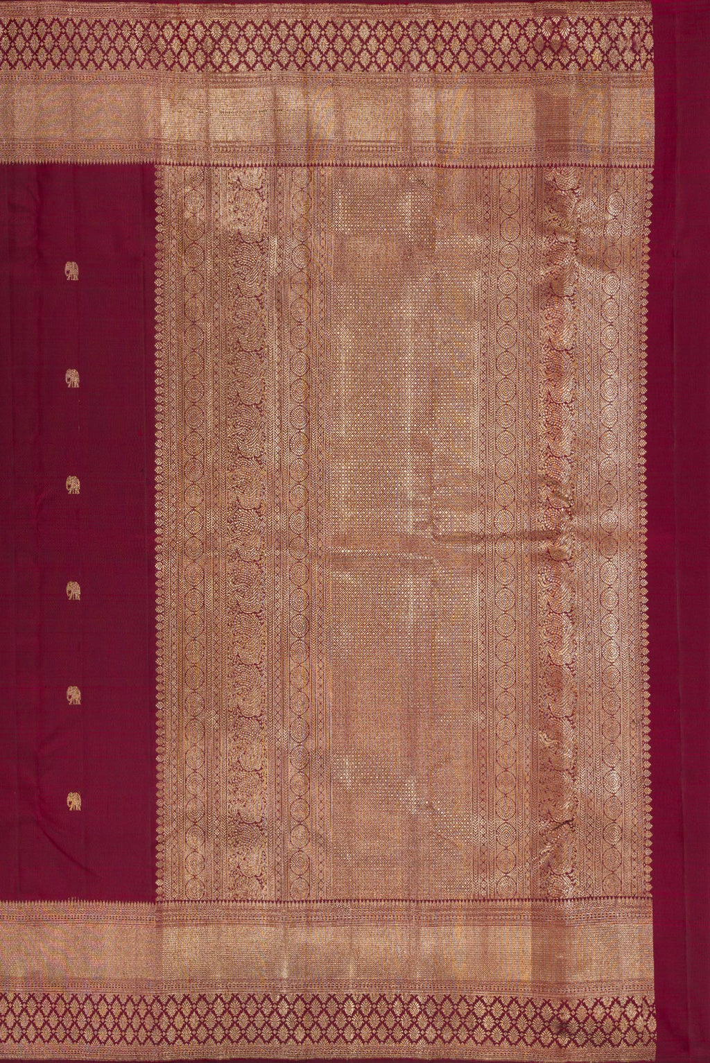 Close up image of the pallu of Pure Silk Maroon Kanjivaram Saree with Zari Butta on the body and Fancy Border. 
