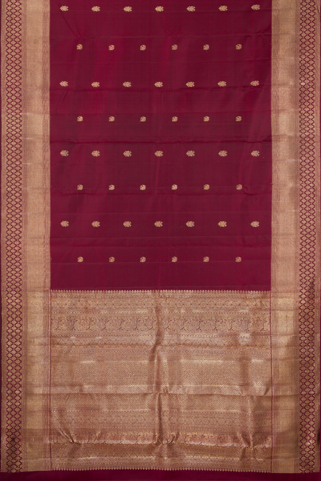 Flat view of Pure Silk Maroon Kanjivaram Saree with Zari Butta on the body and Fancy Border. 