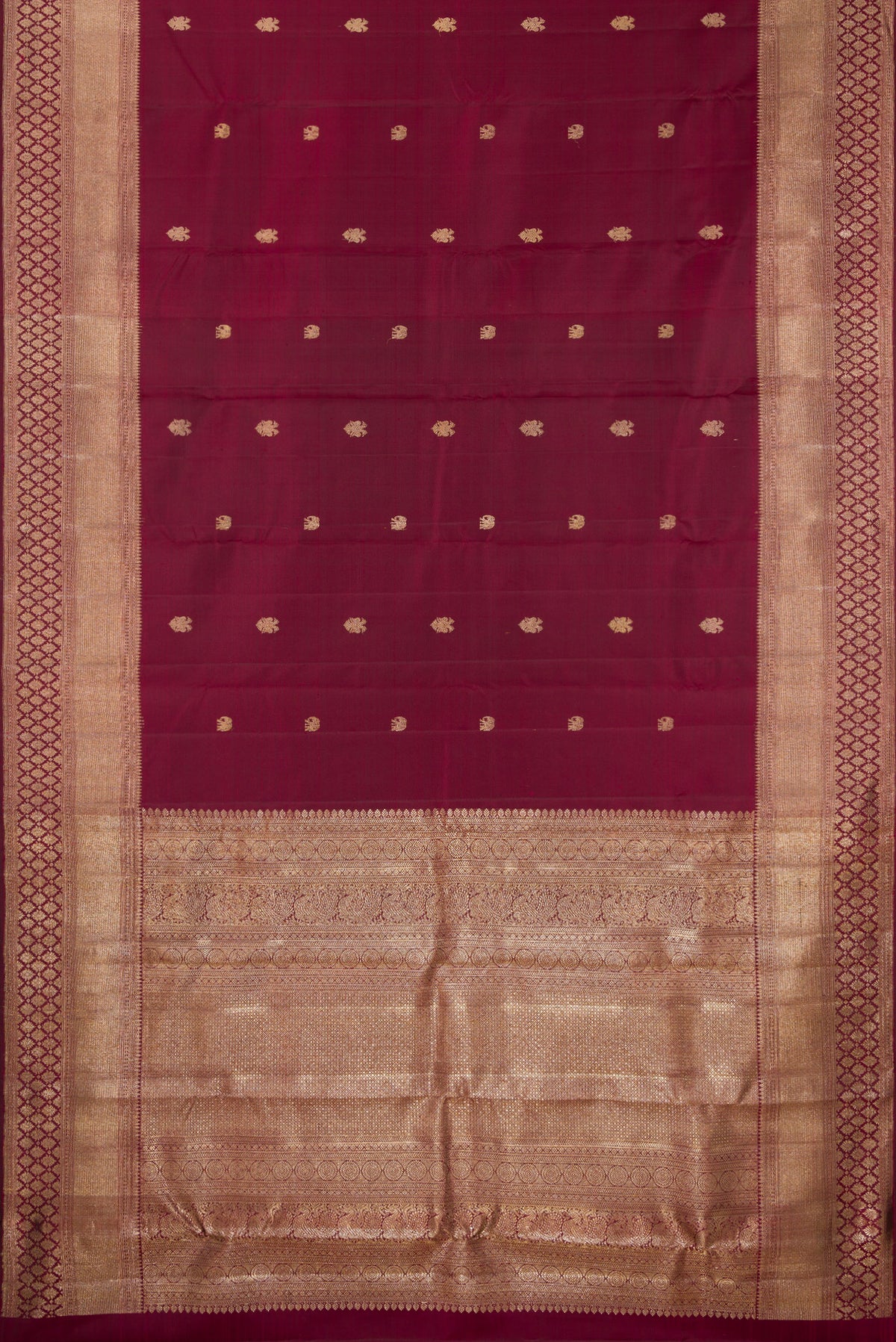 Flat view of Pure Silk Maroon Kanjivaram Saree with Zari Butta on the body and Fancy Border. 
