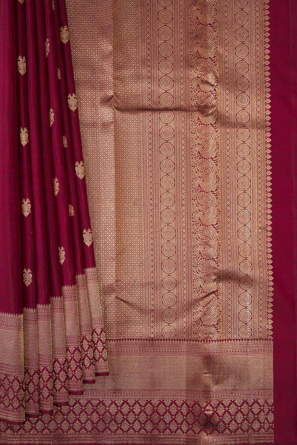 Pleats and pallu of Pure Silk Maroon Kanjivaram Saree with Zari Butta on the body and Fancy Border. 