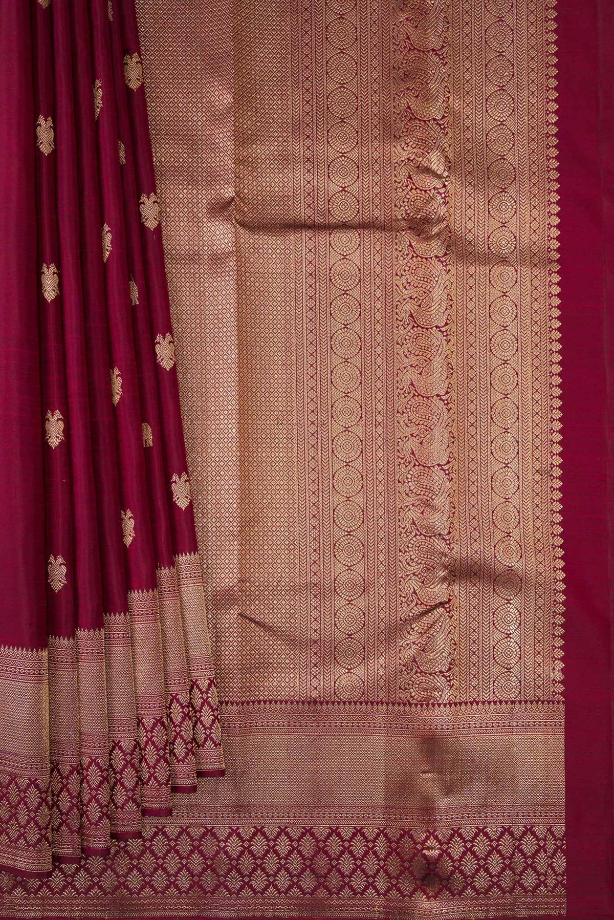Pleats and pallu of Pure Silk Maroon Kanjivaram Saree with Zari Butta on the body and Fancy Border. 