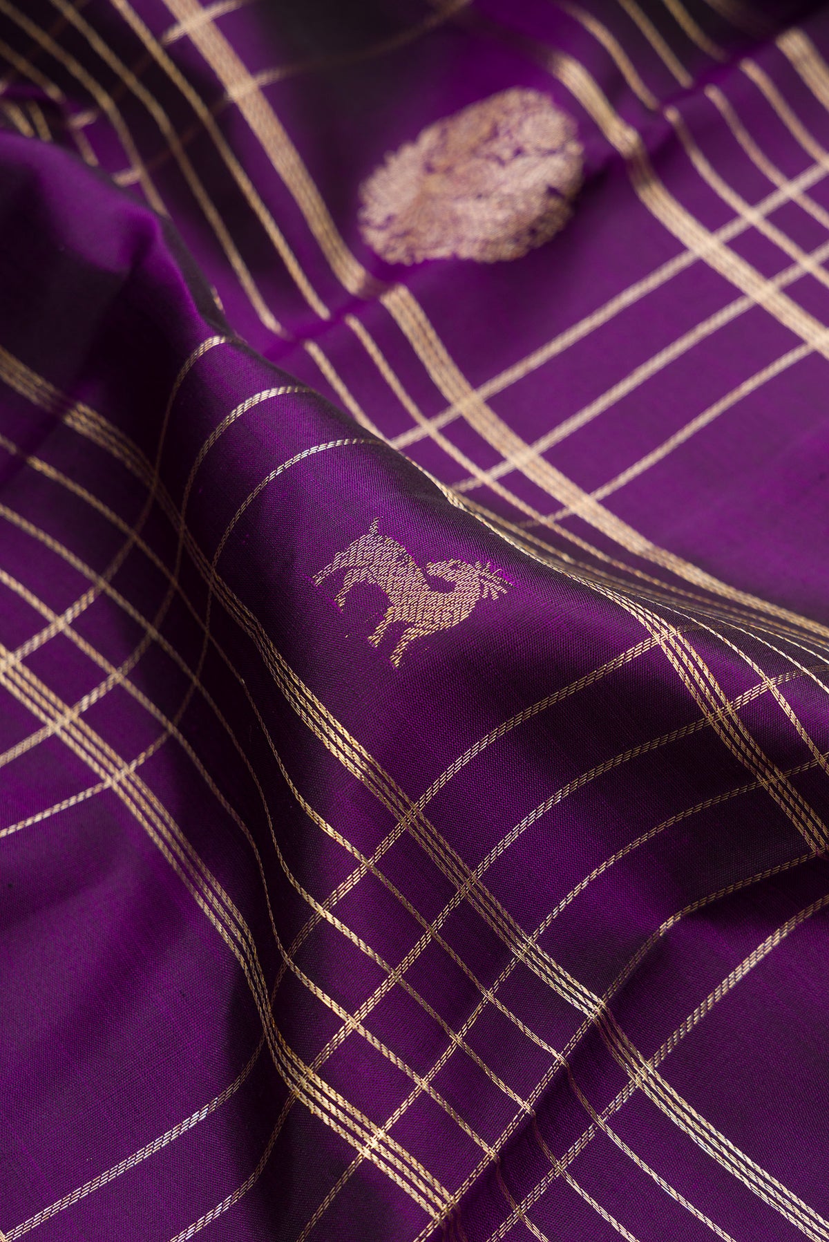 Close up of Pure Silk Violet Dual Tone Kanchipuram Saree with Checked design on the body and Zari Border.  displaying folds