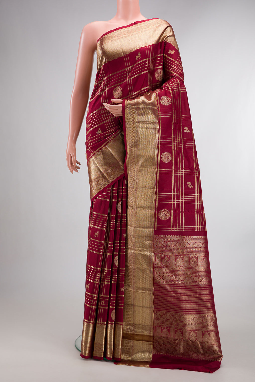 Pure Silk Maroon Kanchipuram Saree with Checked design on the body and Zari Border.  displayed on a mannequin