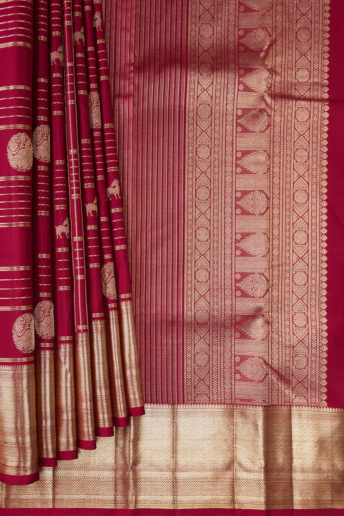 Pleats and pallu of Pure Silk Maroon Kanchipuram Saree with Checked design on the body and Zari Border. 