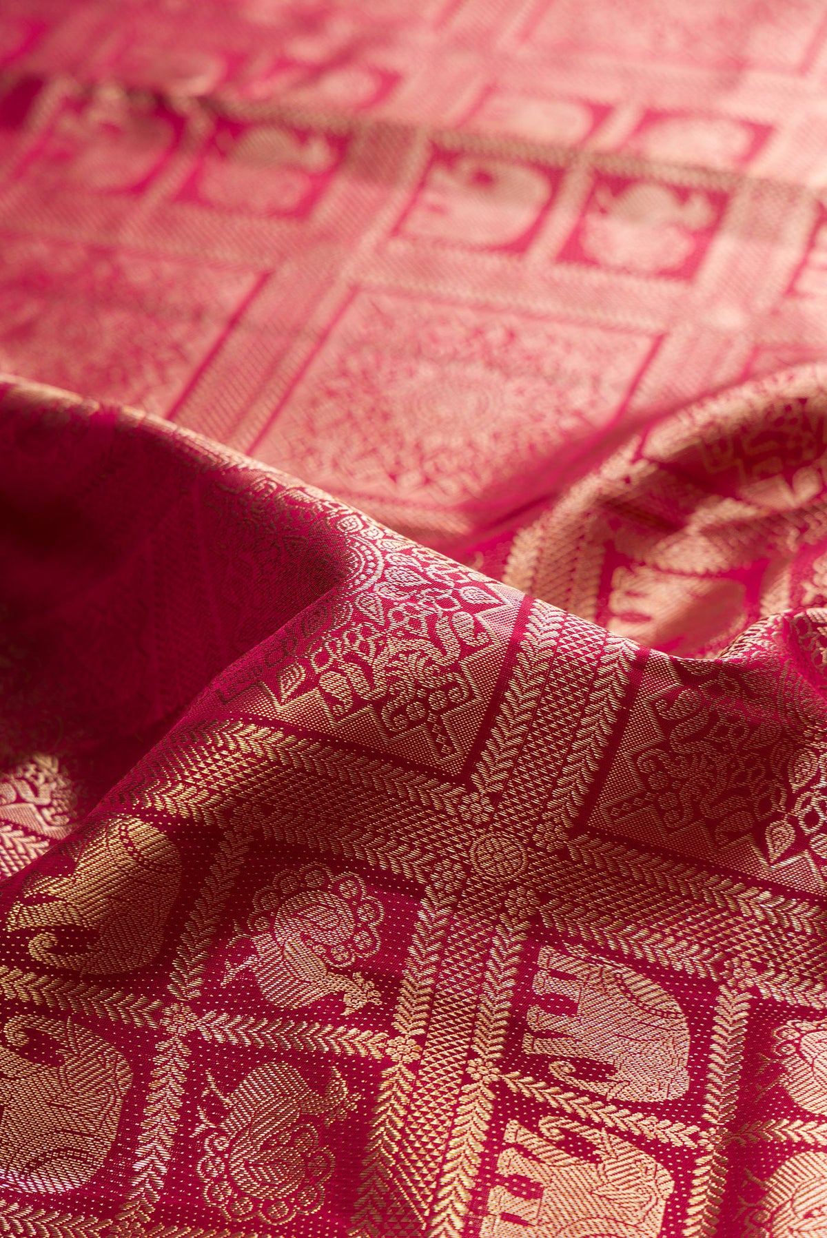 Close up of Pure Silk Maroon Kanchipuram Saree with Zari Brocade on the body and Fancy Border.  displaying folds