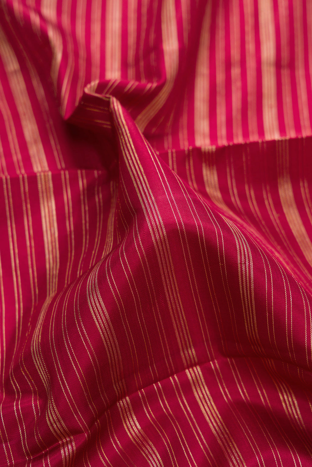 Close up of Pure Silk Red Kanchipuram Saree with Stripes on the body and Temple Border.  displaying folds