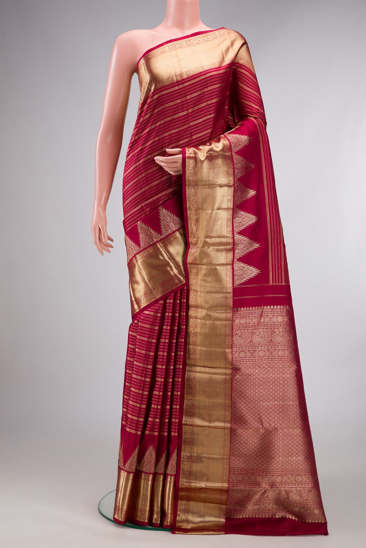 Pure Silk Red Kanchipuram Saree with Stripes on the body and Temple Border.  displayed on a mannequin