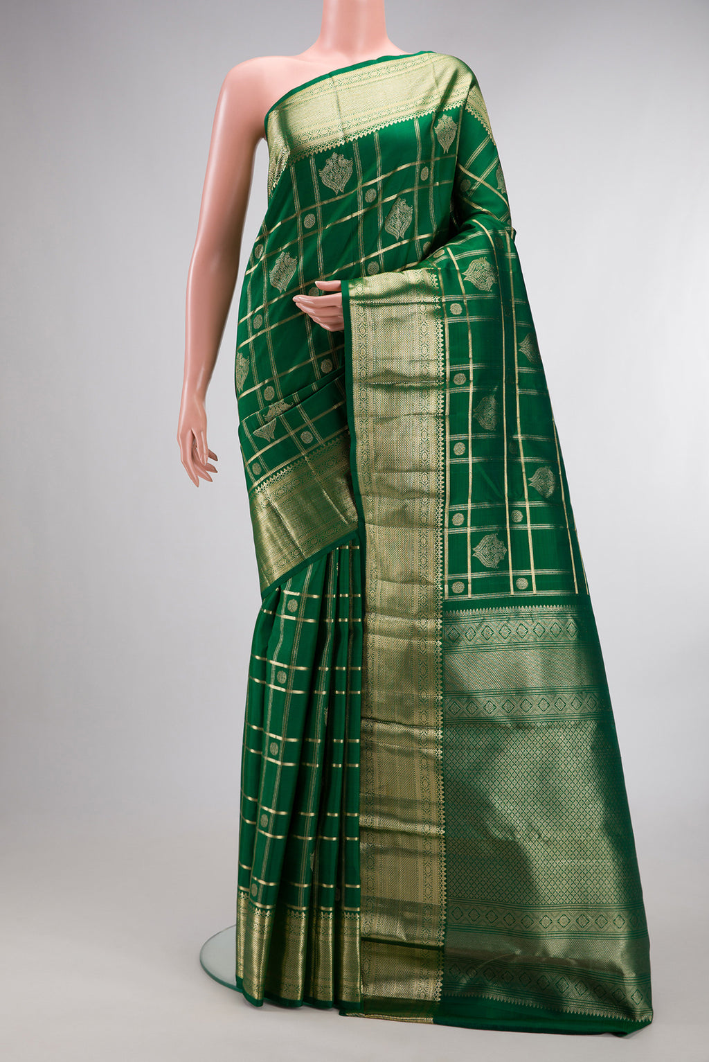 Pure Silk Green Kanchipuram Saree with Checked design on the body and Zari Border.  displayed on a mannequin