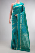 Pure Silk Turquoise Kanchipuram Saree with Checked design on the body and Zari Border.  displayed on a mannequin