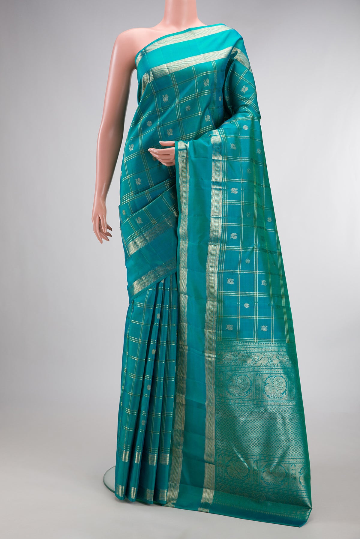 Pure Silk Turquoise Kanchipuram Saree with Checked design on the body and Zari Border.  displayed on a mannequin