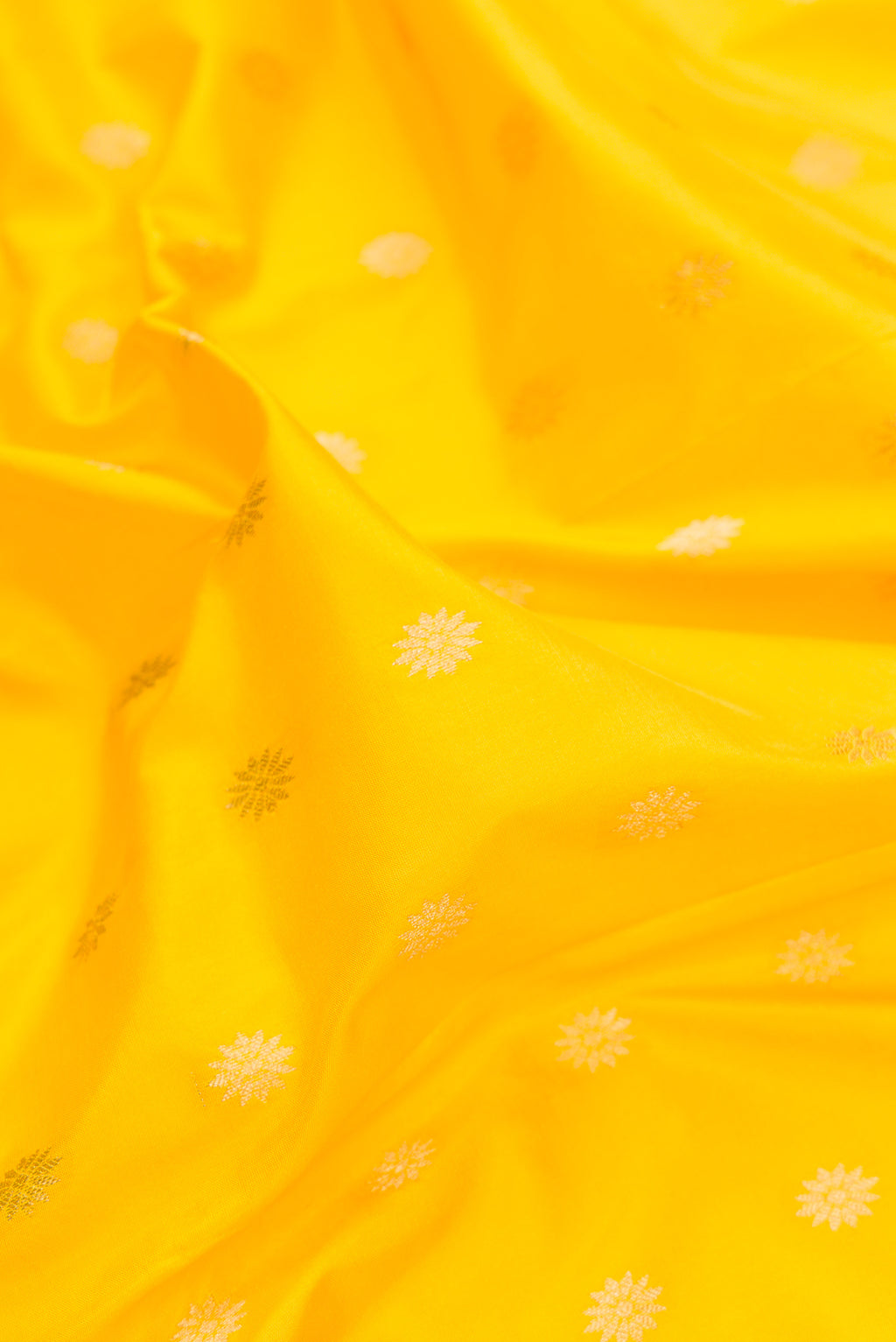 Close up of Pure Silk Yellow Paithani Saree with Zari Butta on the body and Zari Border.  displaying folds