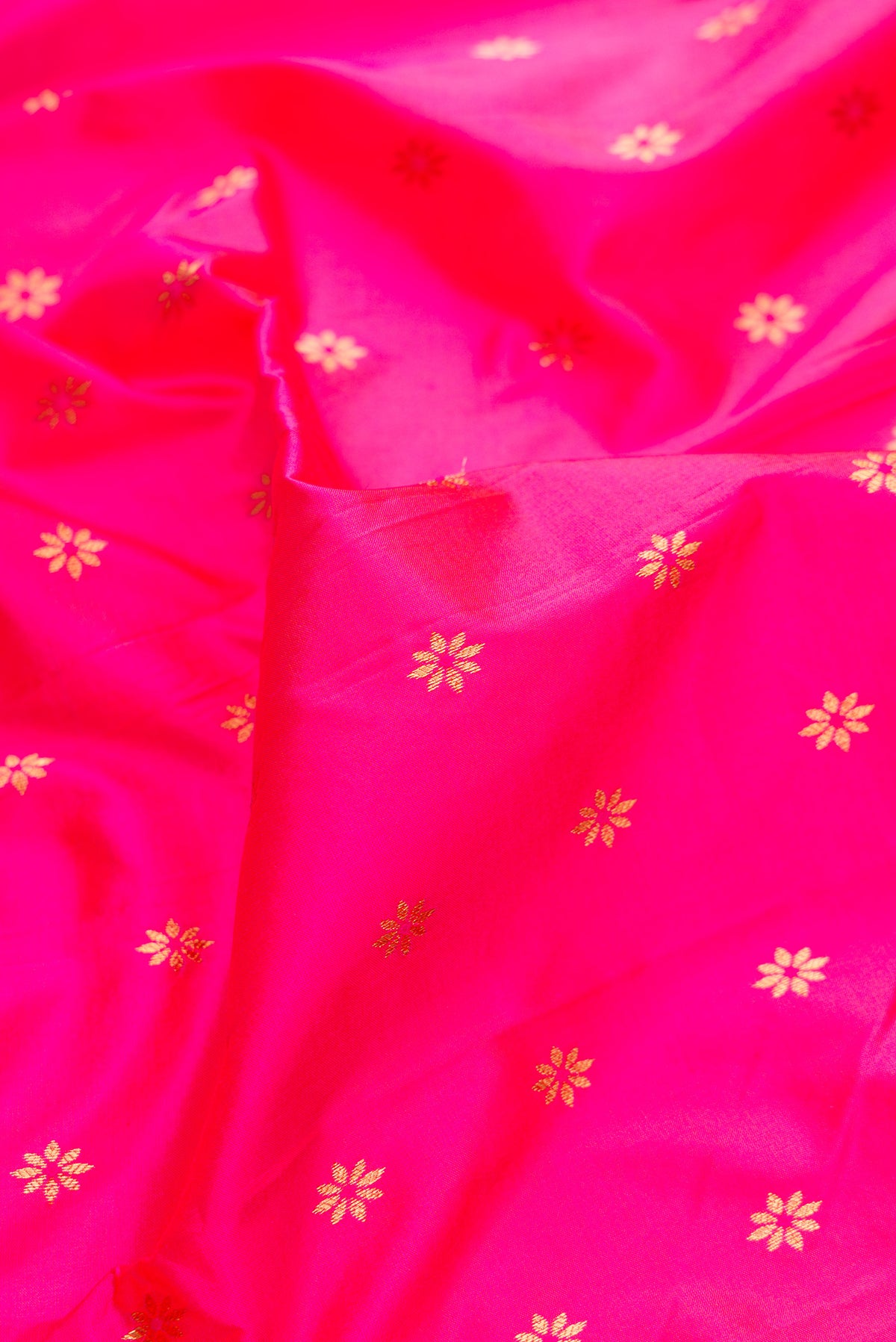 Close up of Pure Silk Pink Paithani Saree with Zari And Thread Butta on the body and Zari Border.  displaying folds
