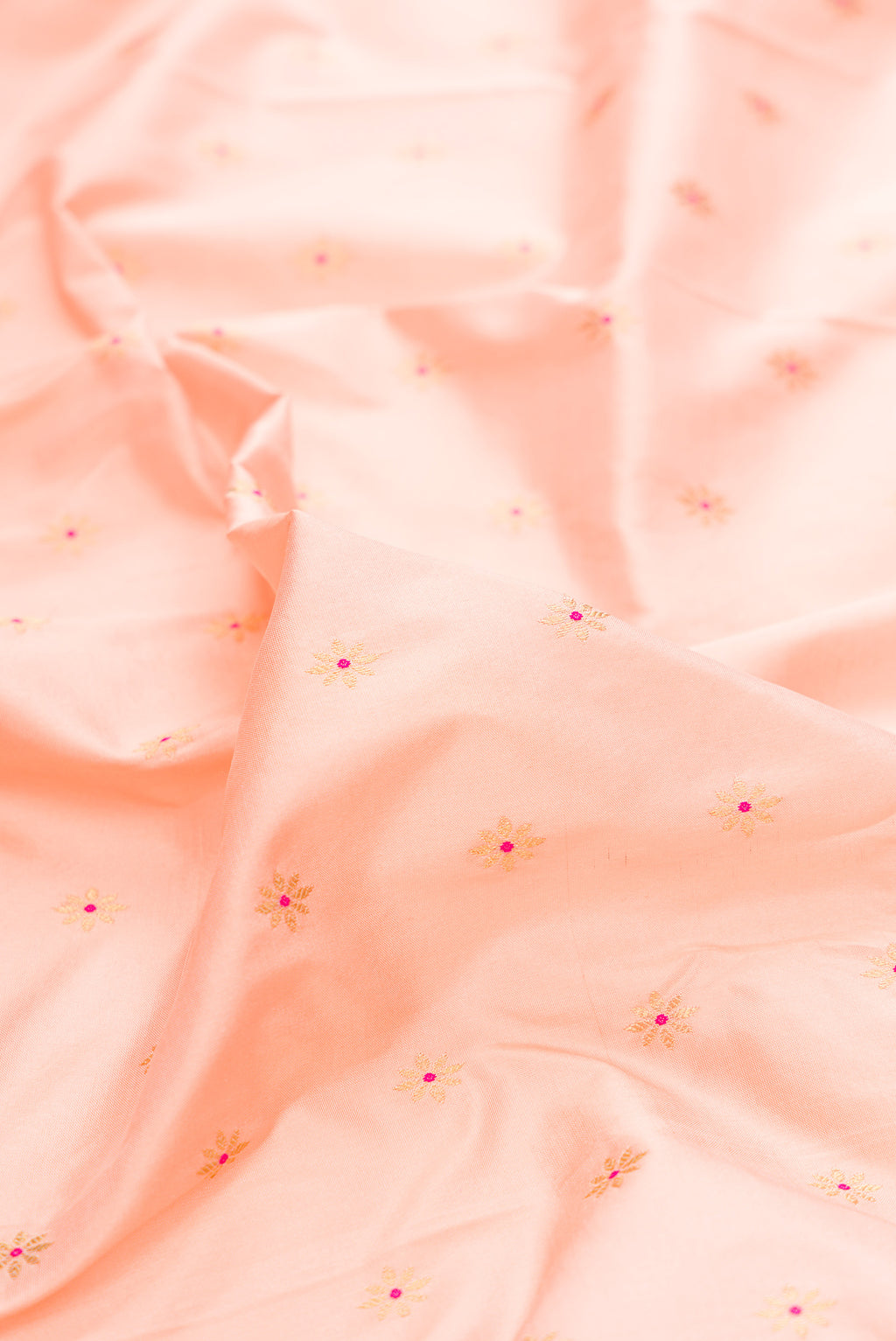 Close up of Pure Silk Peach Paithani Saree with Zari And Thread Butta on the body and Zari Border.  displaying folds