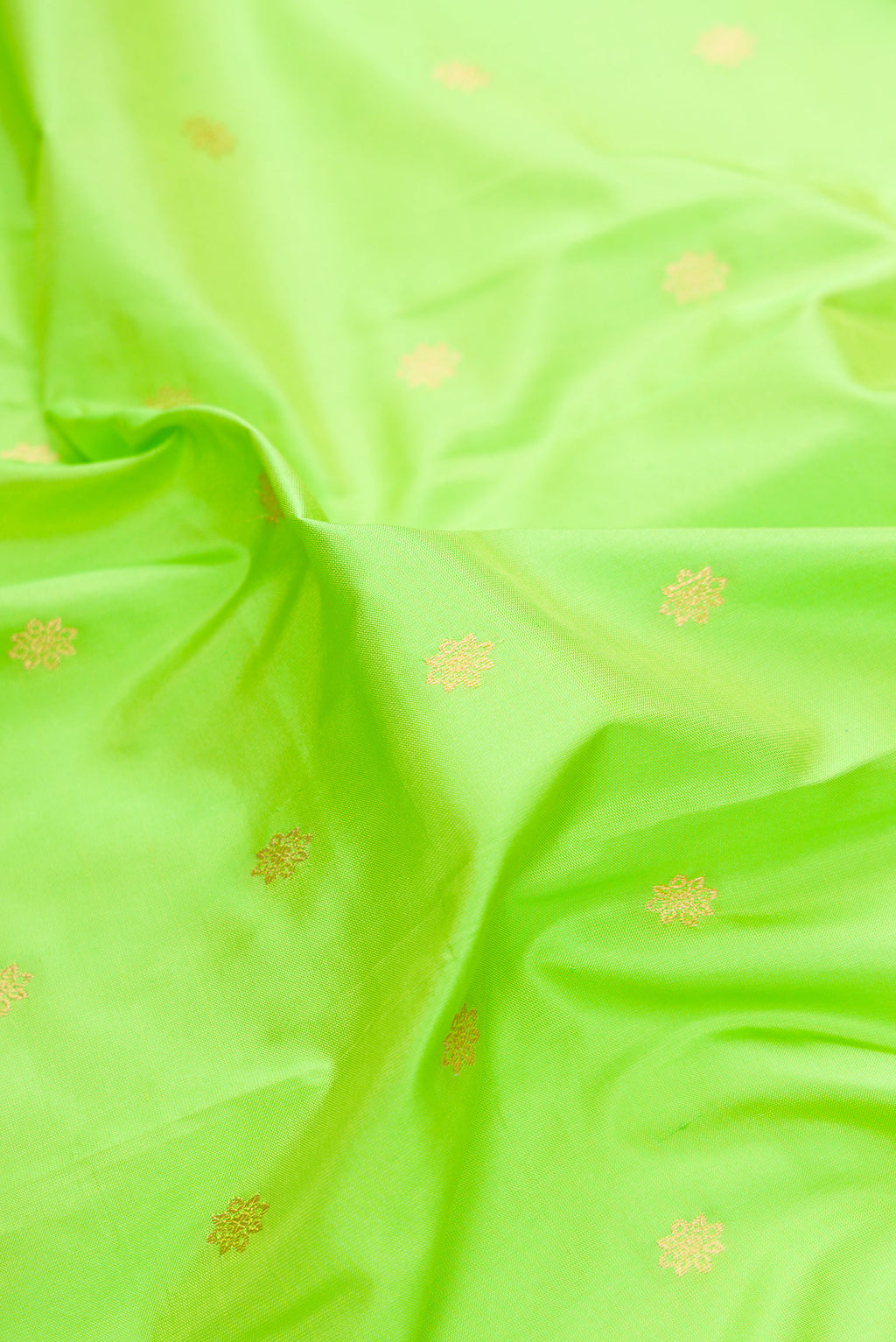 Close up of Pure Silk Parrot Green Paithani Saree with Zari Butta on the body and Zari Border.  displaying folds