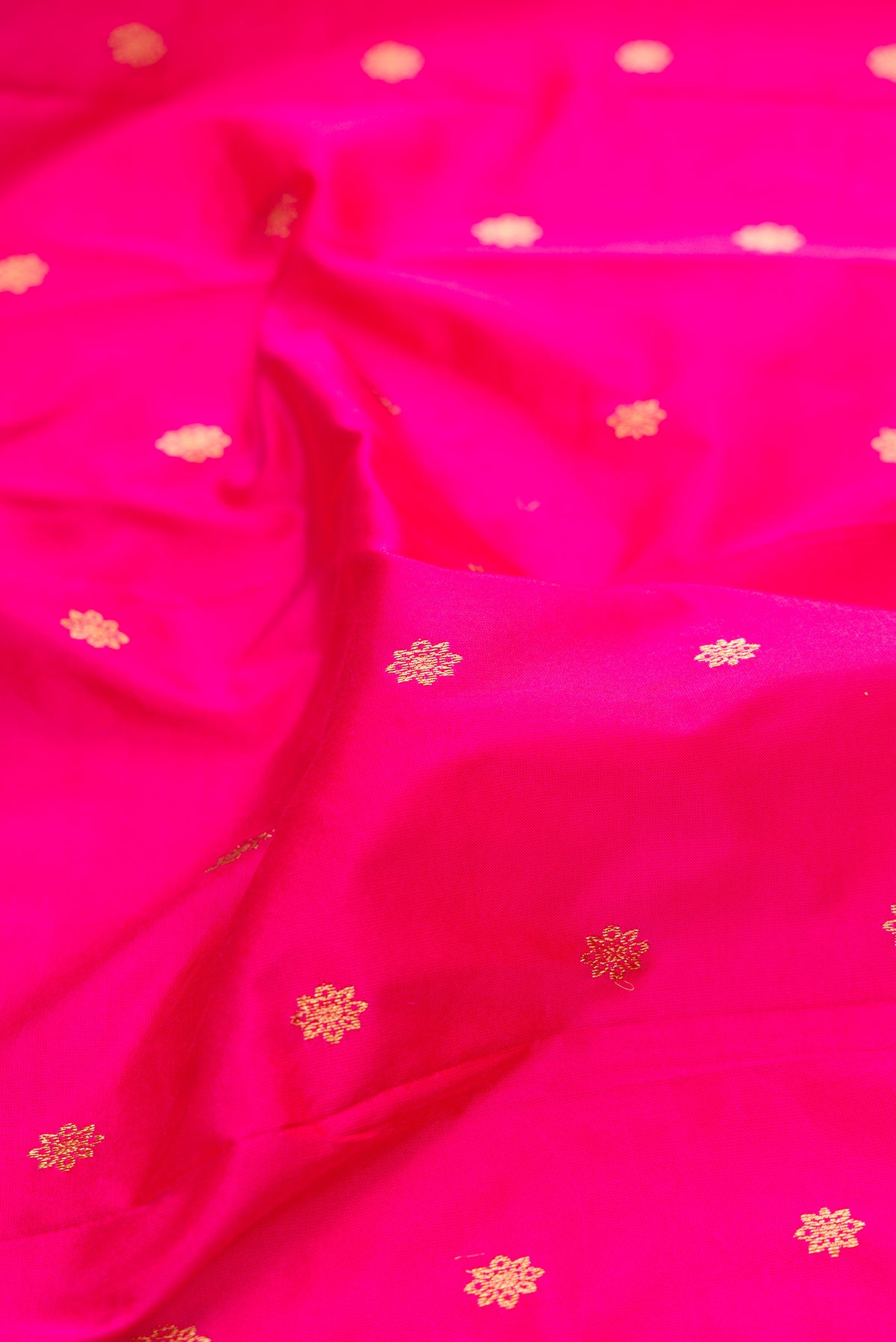 Close up of Pure Silk Pink Paithani Saree with Zari And Thread Butta on the body and Zari Border.  displaying folds